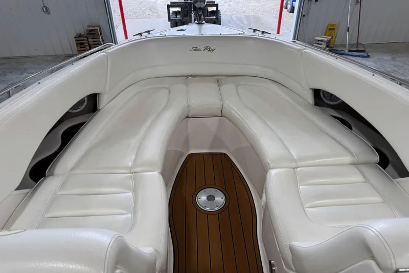 Slide: The Image of 2001 Sea Ray 280 Bow Rider interior with white leather seating and wooden floor. - 8