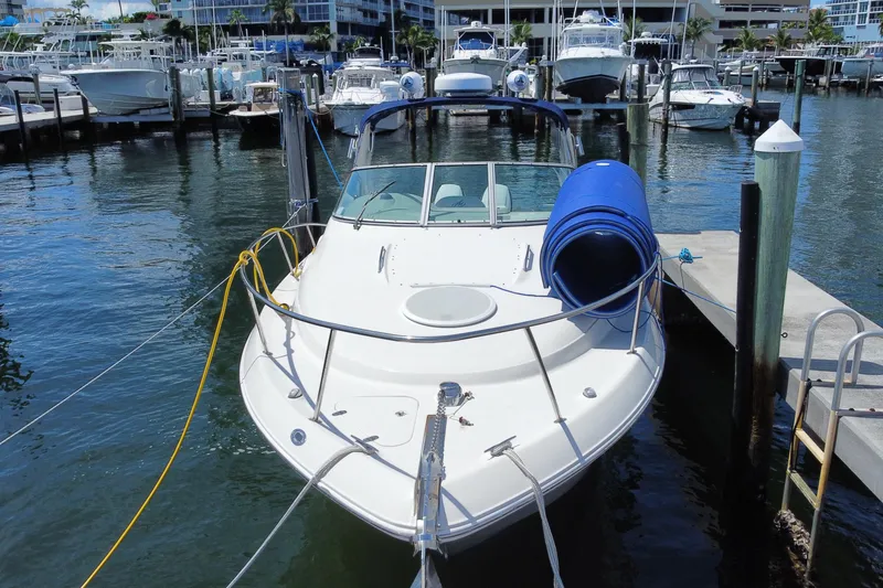 Slide: The Image of 2005 Monterey 302 Cruiser docked at marina, surrounded by other boats. - 1
