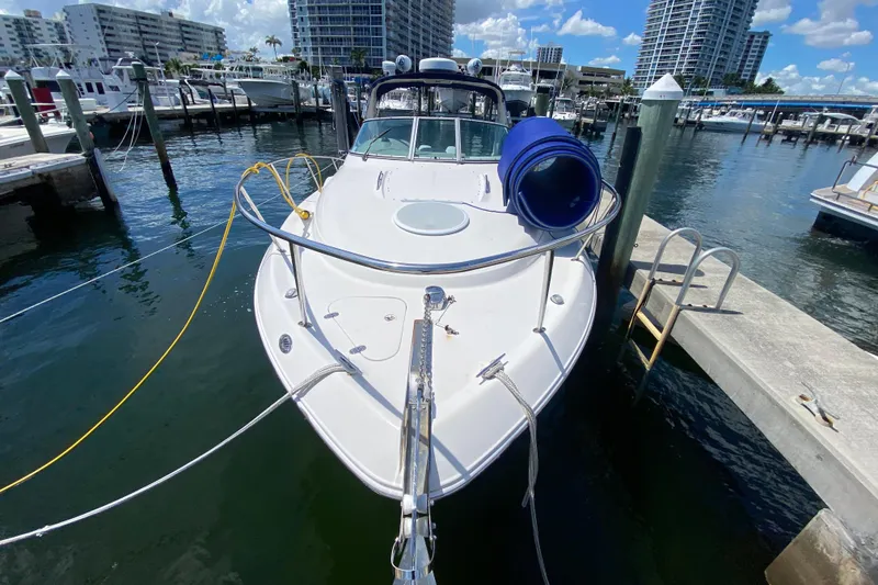 Slide: The Image of 2005 Monterey 302 Cruiser docked at marina with cityscape background. - 10