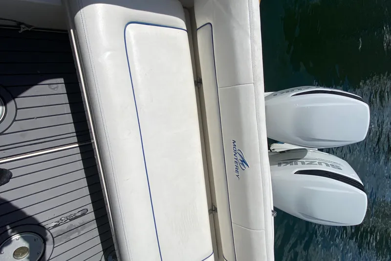 Slide: The Image of 2005 Monterey 302 Cruiser boat with dual Suzuki outboard engines on water. - 17