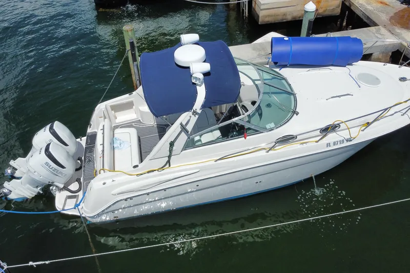 Slide: The Image of 2005 Monterey 302 Cruiser boat docked with dual Suzuki outboard engines. - 28