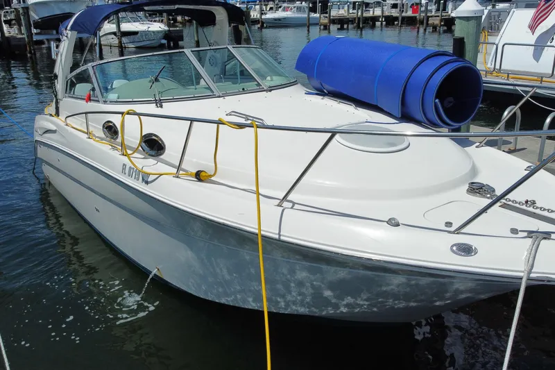 Slide: The Image of 2005 Monterey 302 Cruiser docked at marina with blue mat on deck. - 3