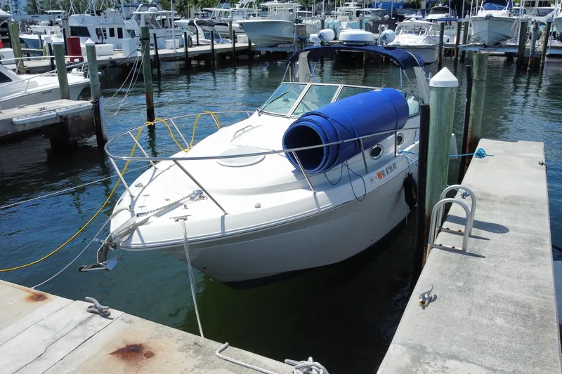 Slide: The Image of 2005 Monterey 302 Cruiser docked at a marina with blue fenders. - 4