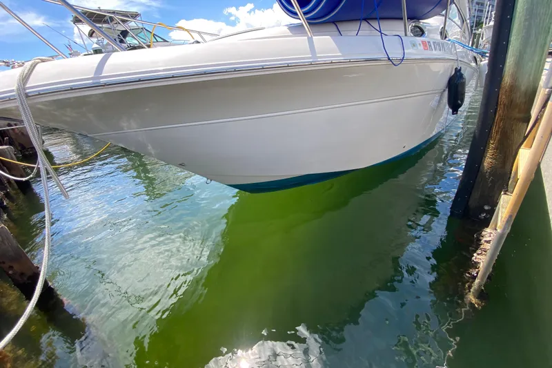 Slide: The Image of 2005 Monterey 302 Cruiser docked in clear water, side view. - 7