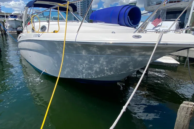 Slide: The Image of 2005 Monterey 302 Cruiser docked at marina, sunny day, calm water reflections. - 9