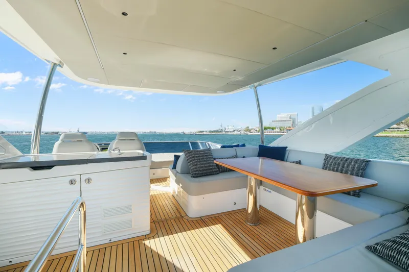 Slide: The Image of Luxurious interior of 2025 Absolute 56 FLY yacht with panoramic windows and elegant seating. - 16