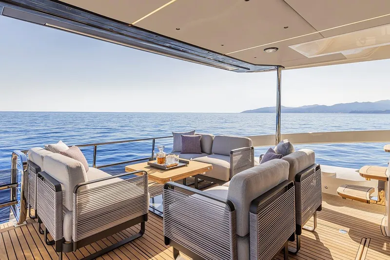 Slide: The Image of 2025 Absolute 56 FLY yacht cruising near city skyline on a sunny day. - 2