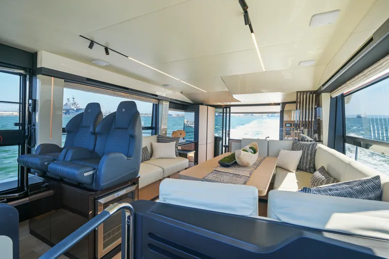 Slide: The Image of Luxurious 2025 Absolute 56 FLY yacht interior with plush seating and ocean view. - 44