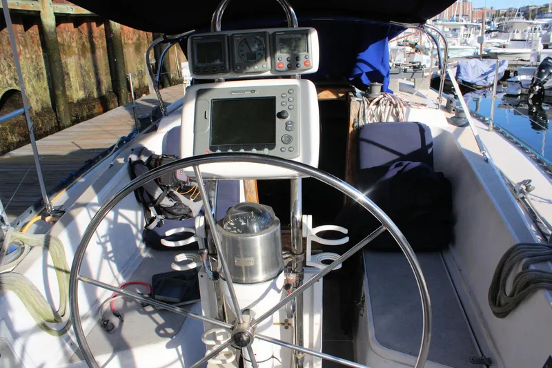 Slide: The Image of Cockpit of a 1976 Tartan 38 sailboat with steering wheel and navigation equipment. - 11