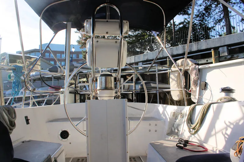 Slide: The Image of Cockpit of a 1976 Tartan 38 sailboat with steering wheel and nautical equipment. - 16