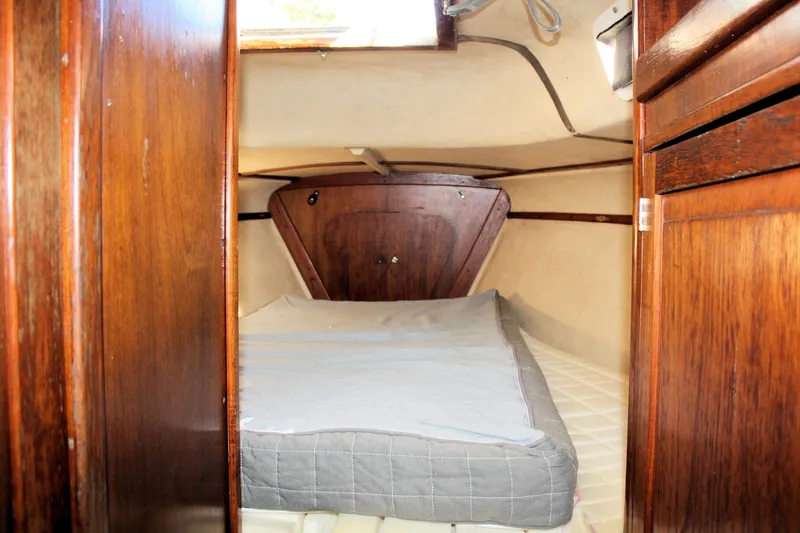 Slide: The Image of Cozy cabin interior of a 1976 Tartan 38 sailboat with wooden finishes. - 18