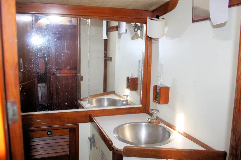 Slide: The Image of 1976 Tartan 38 yacht bathroom with wooden accents and stainless steel sink. - 21
