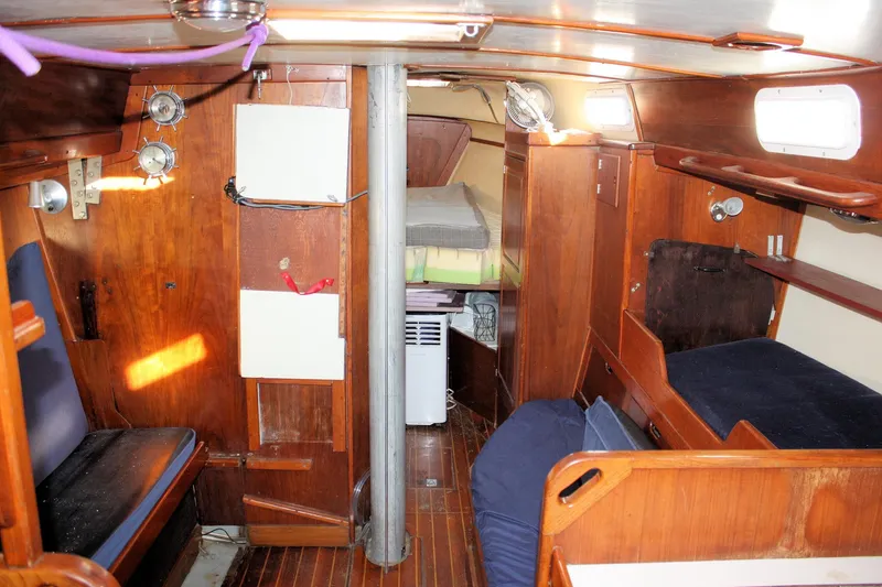 Slide: The Image of Interior of a 1976 Tartan 38 sailboat with wooden furnishings and cozy seating. - 22
