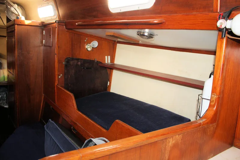 Slide: The Image of 1976 Tartan 38 sailboat interior with wooden cabin and cozy sleeping berth. - 32