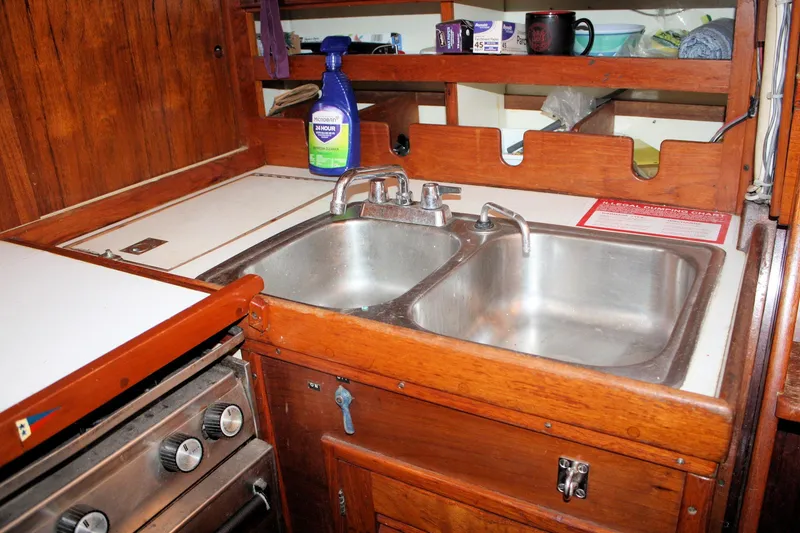 Slide: The Image of 1976 Tartan 38 yacht kitchen with dual sinks and wooden cabinetry. - 35