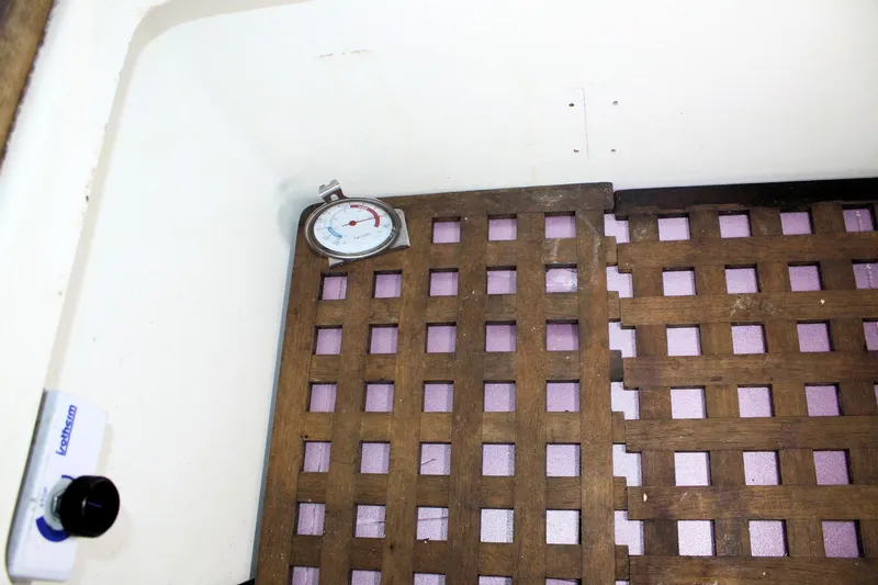 Slide: The Image of Wooden lattice floor with thermometer in 1976 Tartan 38 boat interior. - 37