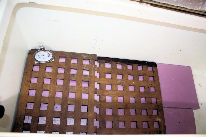 Slide: The Image of Wooden grate with thermometer in Tartan 38, 1976 model, featuring purple insulation. - 38