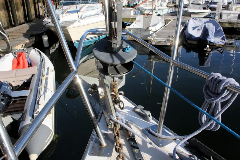 Slide: The Image of Bow of a 1976 Tartan 38 sailboat docked, with ropes and anchor chain visible. - 4