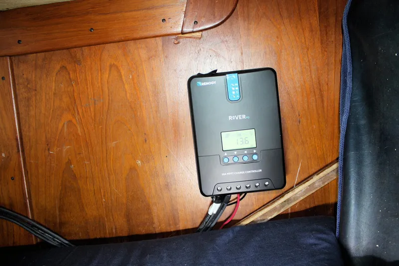 Slide: The Image of Renogy Rover PG charge controller installed on 1976 Tartan 38 wooden interior. - 45