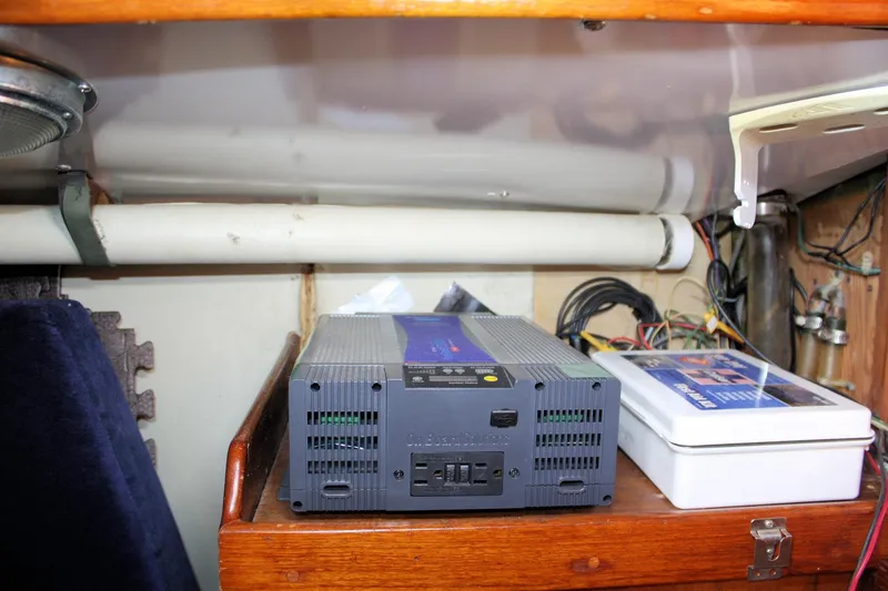 Slide: The Image of Electrical setup inside a 1976 Tartan 38 sailboat, featuring an inverter and wiring. - 48