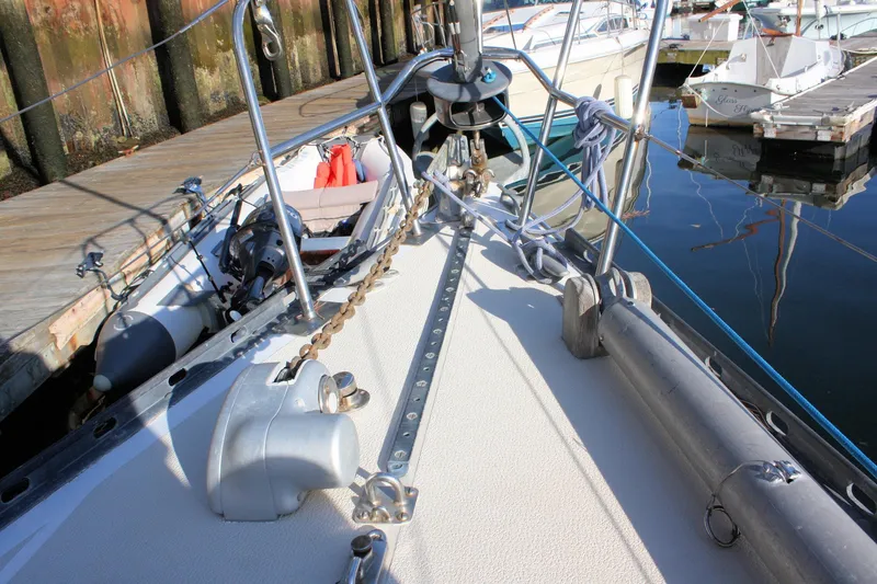 Slide: The Image of 1976 Tartan 38 sailboat deck with anchor chain and docked marina view. - 5