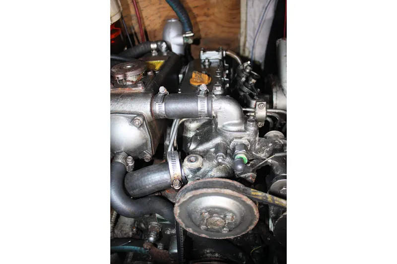 Slide: The Image of Engine of a 1976 Tartan 38 sailboat, featuring hoses and mechanical components. - 51