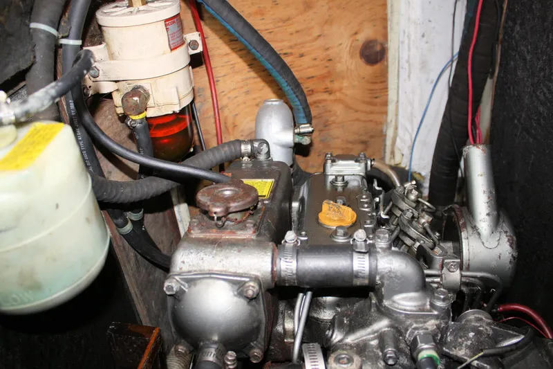 Slide: The Image of Engine compartment of a 1976 Tartan 38 sailboat, showcasing mechanical components and wiring. - 52