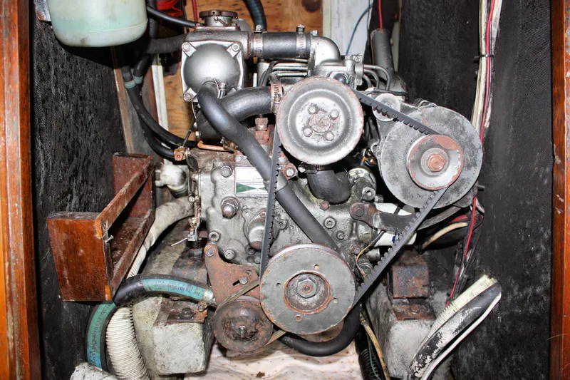 Slide: The Image of 1976 Tartan 38 engine compartment with visible belts and hoses. - 54