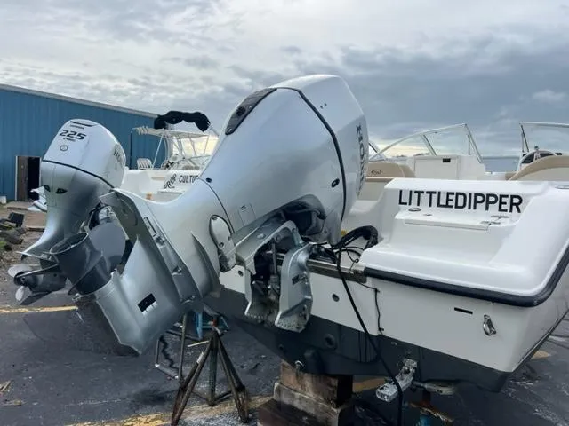 Slide: The Image of 2020 Key West 203 DFS boat with outboard motor, named Littledipper, in a marina. - 2