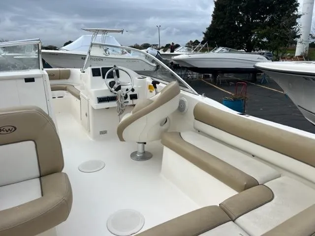 Slide: The Image of 2020 Key West 203 DFS boat interior with beige seating and steering console. - 4