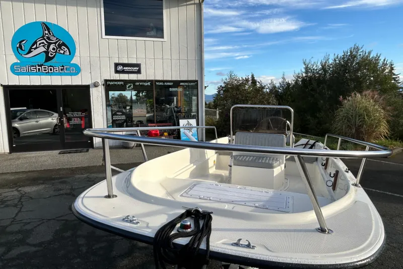 Slide: The Image of 1990 Wahoo 16.2 Striper boat displayed outside Salish Boat Co. store. - 14