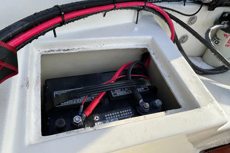 Slide: The Image of Battery compartment of a 1990 Wahoo 16.2 Striper boat with red and black cables. - 7