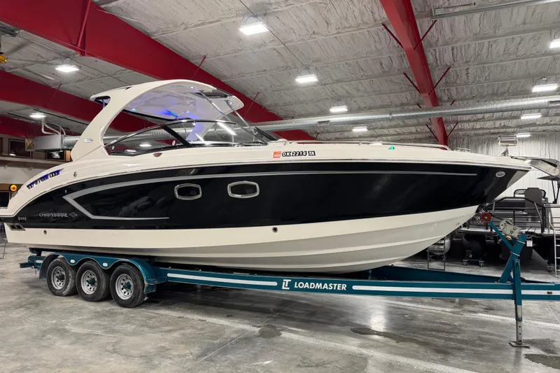 The Image of 2014 Chaparral 327 SSX boat on Loadmaster trailer in indoor storage. - 1