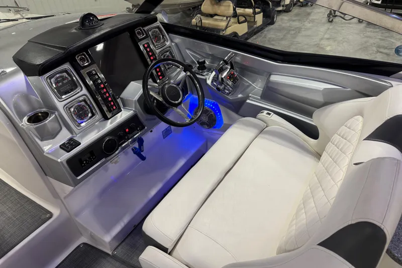Slide: The Image of 2014 Chaparral 327 SSX boat cockpit with modern controls and white seating. - 11