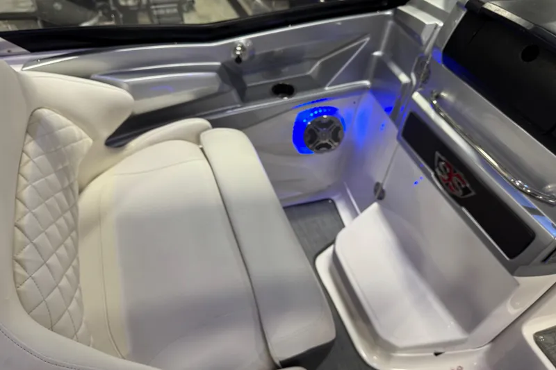 Slide: The Image of Luxurious interior of 2014 Chaparral 327 SSX boat with white seating and blue LED lighting. - 12