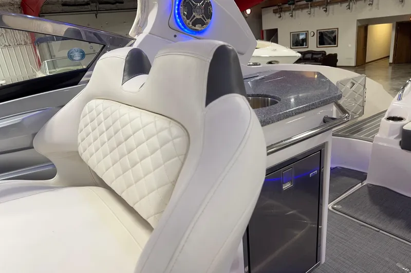 Slide: The Image of Luxurious interior of 2014 Chaparral 327 SSX boat with white seating and kitchenette. - 13