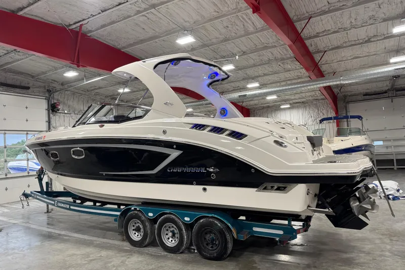 Slide: The Image of 2014 Chaparral 327 SSX boat on trailer in indoor storage facility. - 3