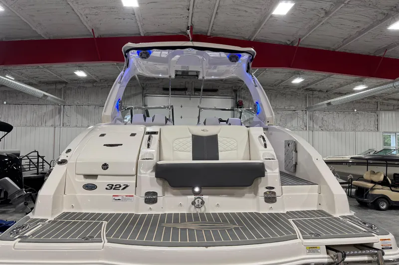 Slide: The Image of 2014 Chaparral 327 SSX boat in showroom, rear view with seating and deck. - 5