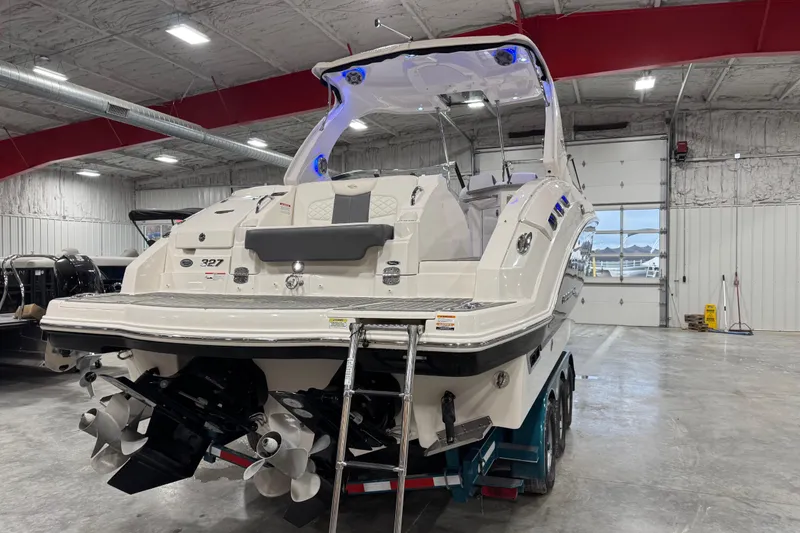 Slide: The Image of 2014 Chaparral 327 SSX boat in a spacious indoor storage facility. - 6