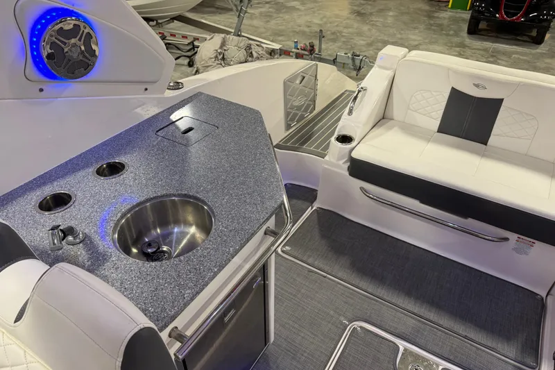 Slide: The Image of 2014 Chaparral 327 SSX boat interior with sink, seating, and speaker system. - 8