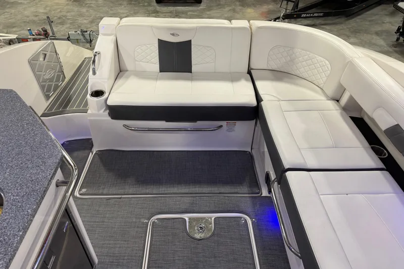 Slide: The Image of 2014 Chaparral 327 SSX boat interior with white seating and modern design. - 9