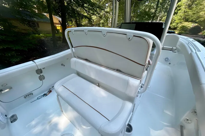 Slide: The Image of 2021 Sea Hunt Ultra 255 SE boat interior with white seating and console. - 8