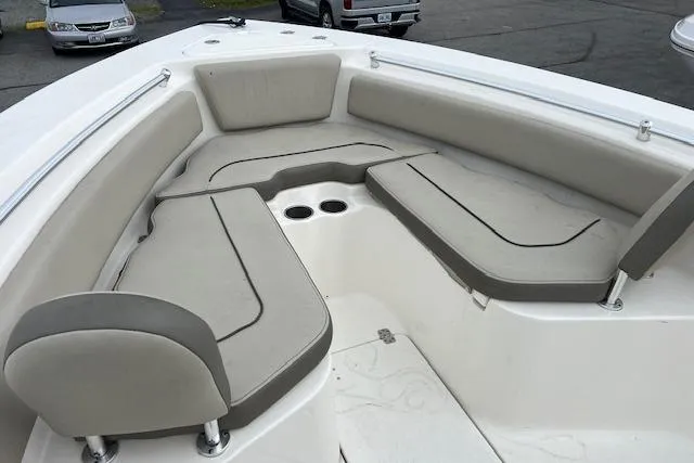 Slide: The Image of 2021 Key West 239 FS boat interior with cushioned seating and cup holders. - 5