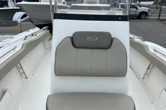 Slide: The Image of 2021 Key West 239 FS boat interior with beige seating and KW logo. - 9