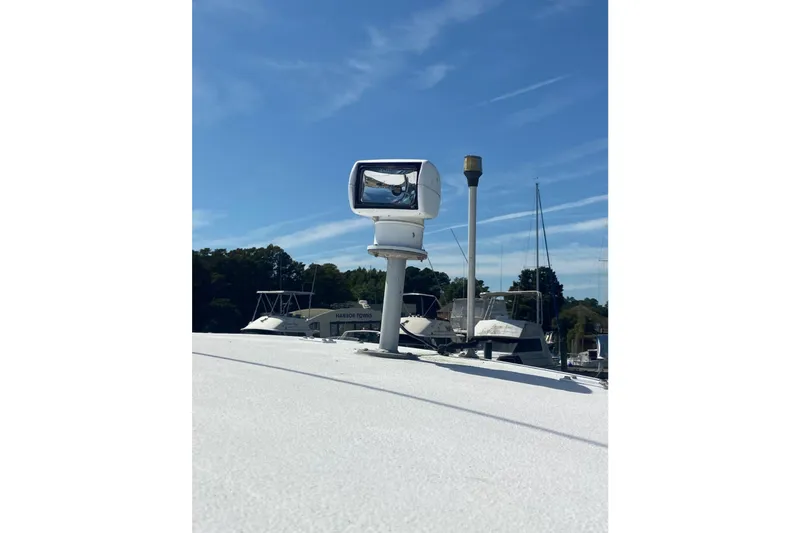 Slide: The Image of 1987 Luhrs 30 Alura Classic boat spotlight and mast against blue sky. - 14