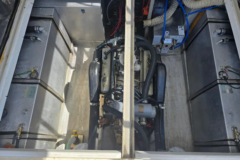 Slide: The Image of Engine compartment of 1987 Luhrs 30 Alura Classic boat, showing engine and components. - 16