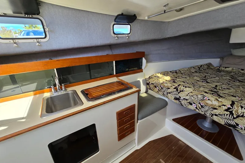 Slide: The Image of 1987 Luhrs 30 Alura Classic cabin interior with kitchenette and bed. - 17