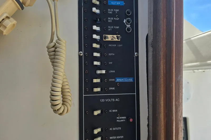 Slide: The Image of Control panel of 1987 Luhrs 30 Alura Classic boat with coiled cable. - 27