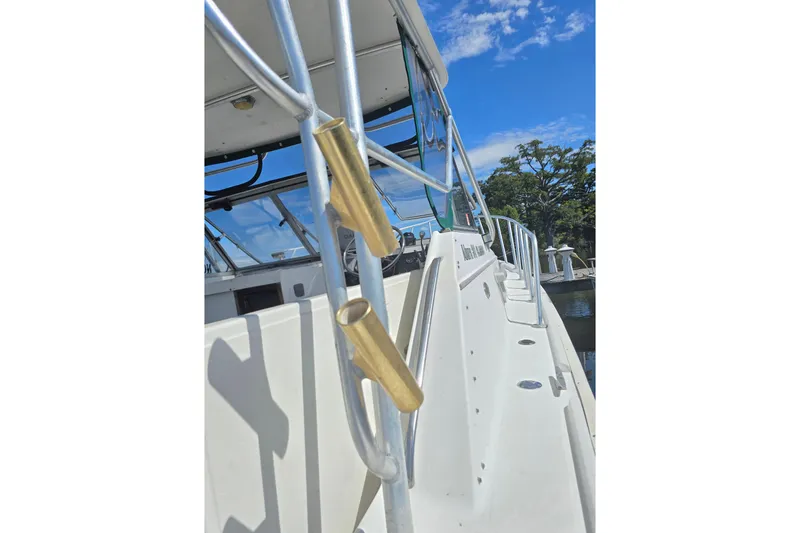 Slide: The Image of 1987 Luhrs 30 Alura Classic boat with brass fittings and clear blue sky. - 28