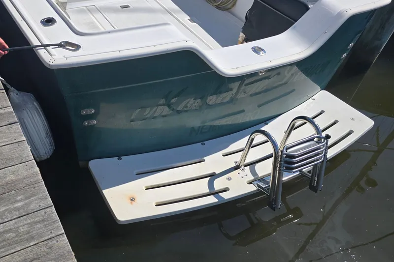 Slide: The Image of 1987 Luhrs 30 Alura Classic boat stern with swim platform and ladder. - 30